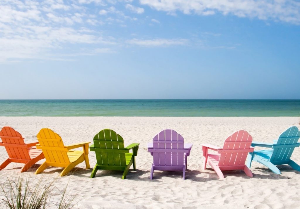Rainbow chairs on a beach in the summertime | My Workforce Go!