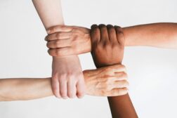 four hands interlocking